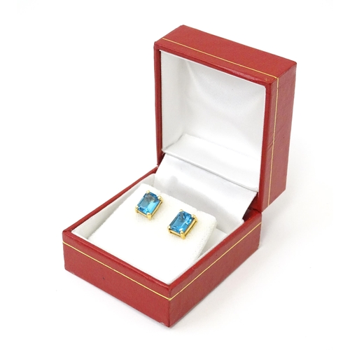 700 - A pair of 18ct gold stud earrings set with topaz. Approx 1/4