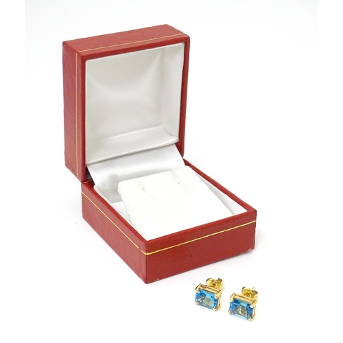 700 - A pair of 18ct gold stud earrings set with topaz. Approx 1/4