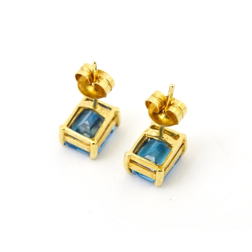 700 - A pair of 18ct gold stud earrings set with topaz. Approx 1/4