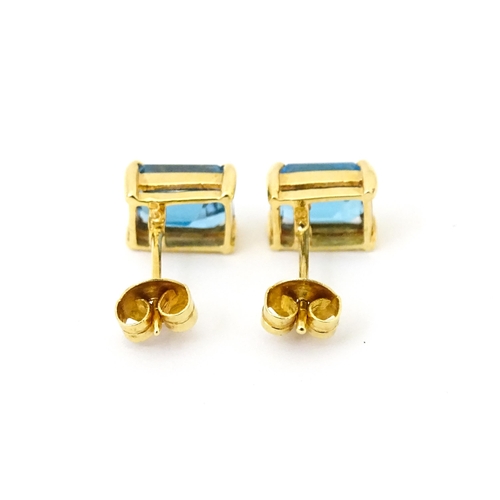 700 - A pair of 18ct gold stud earrings set with topaz. Approx 1/4