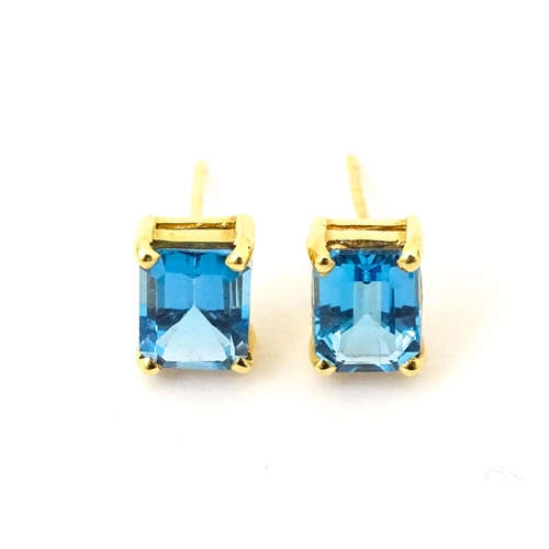 700 - A pair of 18ct gold stud earrings set with topaz. Approx 1/4