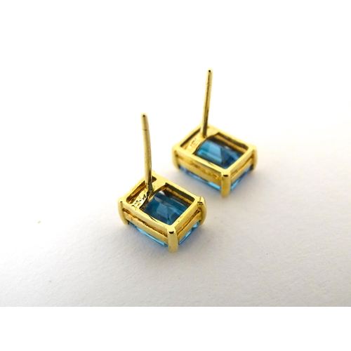 700 - A pair of 18ct gold stud earrings set with topaz. Approx 1/4