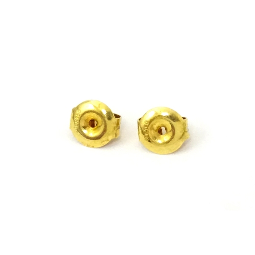 700 - A pair of 18ct gold stud earrings set with topaz. Approx 1/4