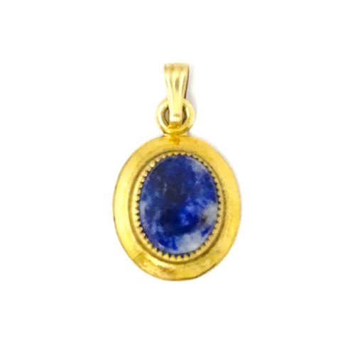 702 - A Continental gilt metal pendant with lapiz lazuli set to centre 3/4