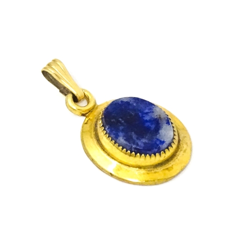 702 - A Continental gilt metal pendant with lapiz lazuli set to centre 3/4