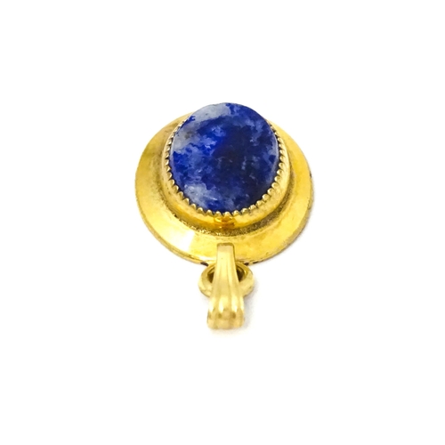 702 - A Continental gilt metal pendant with lapiz lazuli set to centre 3/4