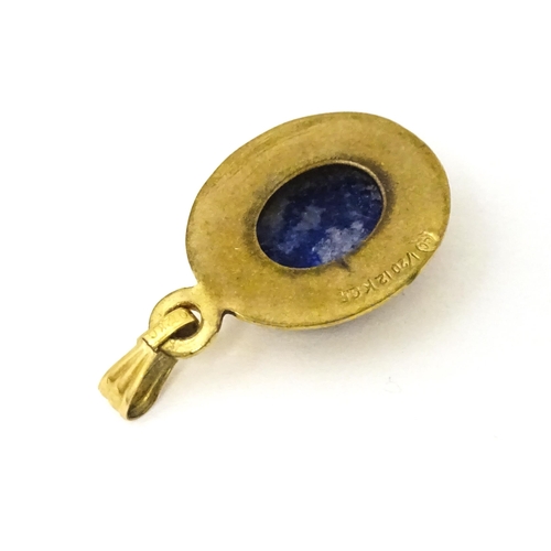 702 - A Continental gilt metal pendant with lapiz lazuli set to centre 3/4