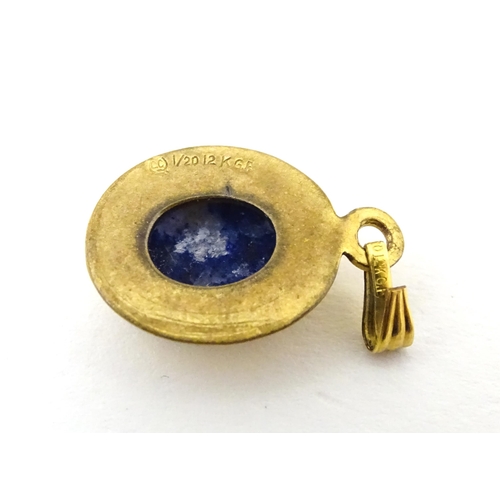 702 - A Continental gilt metal pendant with lapiz lazuli set to centre 3/4