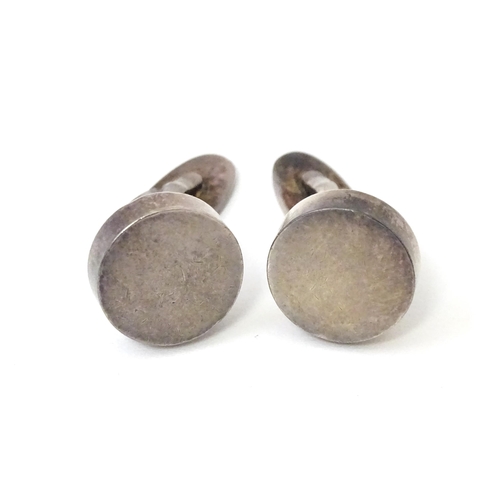 704 - A pair of Danish silver cufflinks by Georg Jensen. Marked 925 S Denmark and numbered 'A24'