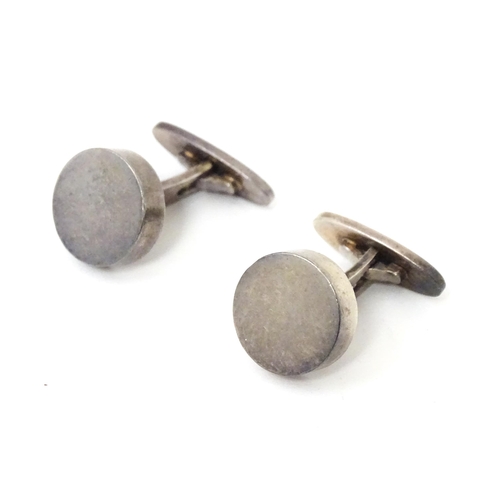 704 - A pair of Danish silver cufflinks by Georg Jensen. Marked 925 S Denmark and numbered 'A24'