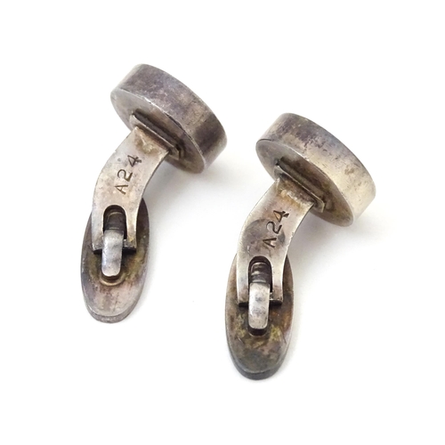 704 - A pair of Danish silver cufflinks by Georg Jensen. Marked 925 S Denmark and numbered 'A24'