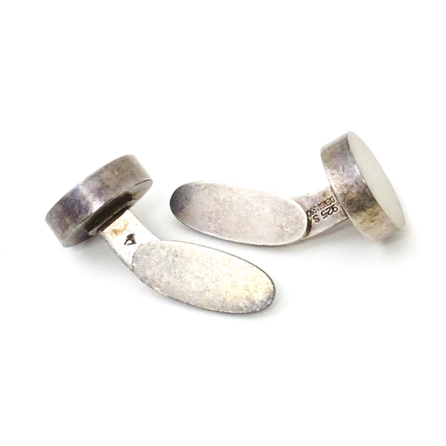 704 - A pair of Danish silver cufflinks by Georg Jensen. Marked 925 S Denmark and numbered 'A24'