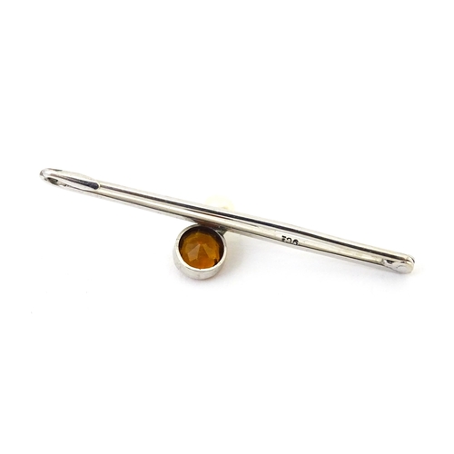 705 - A 9ct white gold broch set with citrine and peal. Together with a white metal brooch set with centra... 