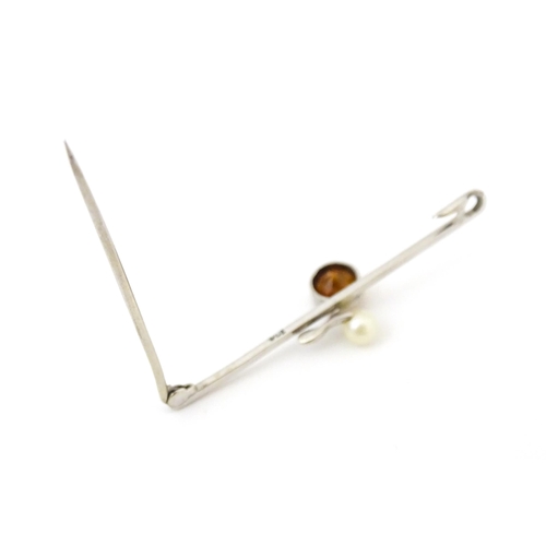 705 - A 9ct white gold broch set with citrine and peal. Together with a white metal brooch set with centra... 