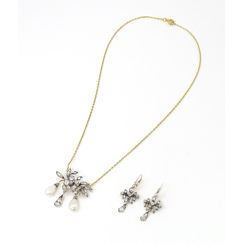 707 - A Continental 14ct gold necklace having a floral and foliate formed pedant set with a profusion of d... 