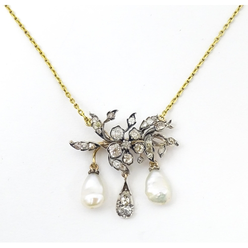 707 - A Continental 14ct gold necklace having a floral and foliate formed pedant set with a profusion of d... 