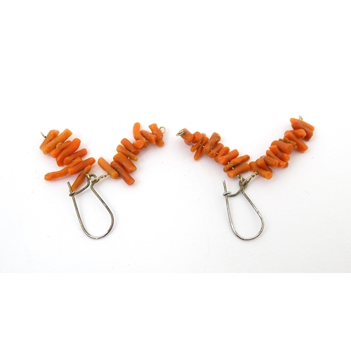 711 - A pair of drop earrings set with coral. Approx. 1 1/4