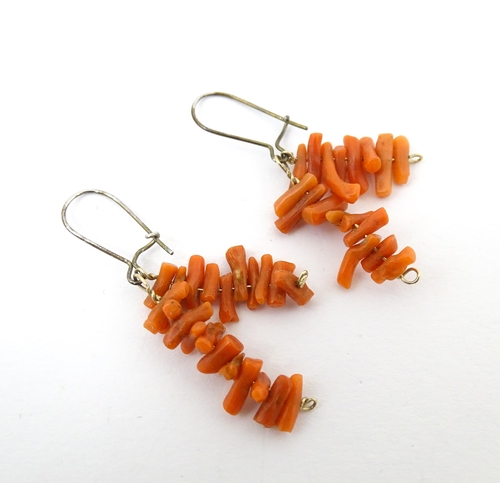 711 - A pair of drop earrings set with coral. Approx. 1 1/4