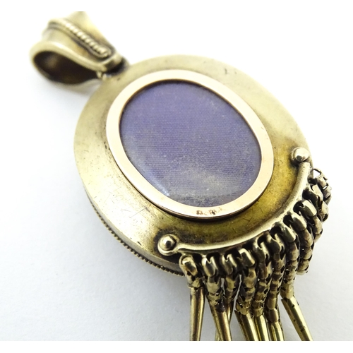 712 - A Victorian yellow metal pendant locket with blue and white enamel detail and central pearl. Approx ... 