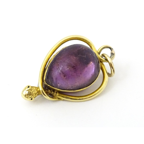 714 - A Victorian pendant of locket form  with central amethyst cabochons within a snake formed scroll sur... 