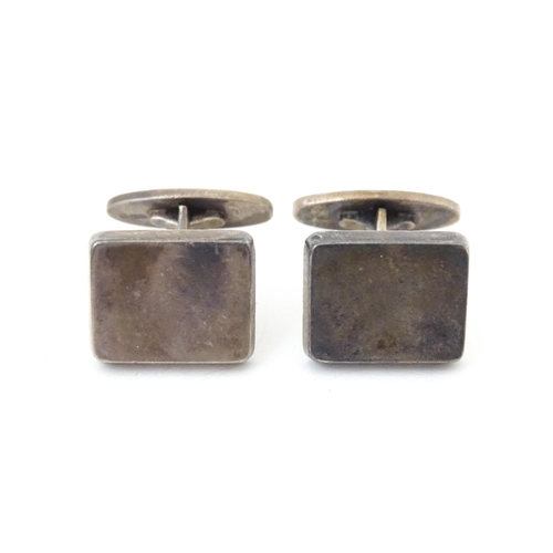 720 - A pair of Danish silver cufflinks designed  by Flemming Eskildsen for Georg Jensen and numbered '84'... 