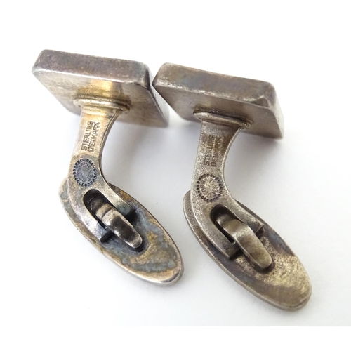 720 - A pair of Danish silver cufflinks designed  by Flemming Eskildsen for Georg Jensen and numbered '84'... 