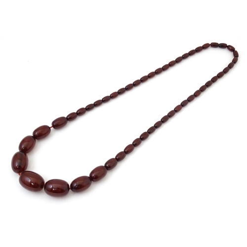 723 - A vintage cherry amber coloured graduated bead necklace. The smallest bead approx 1/2