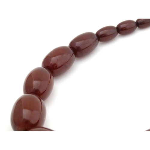 723 - A vintage cherry amber coloured graduated bead necklace. The smallest bead approx 1/2