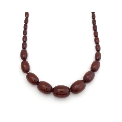 723 - A vintage cherry amber coloured graduated bead necklace. The smallest bead approx 1/2