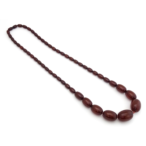 723 - A vintage cherry amber coloured graduated bead necklace. The smallest bead approx 1/2