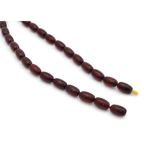 723 - A vintage cherry amber coloured graduated bead necklace. The smallest bead approx 1/2