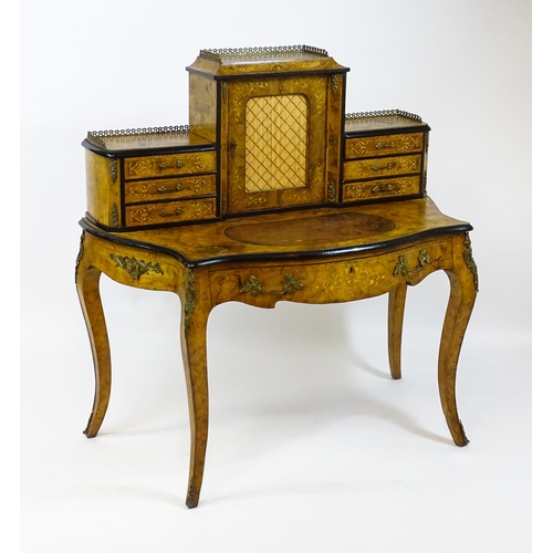 1590 - A 19thC burr walnut Bonheur du jour, with a brass gallery surmounting the two banks of three short d... 