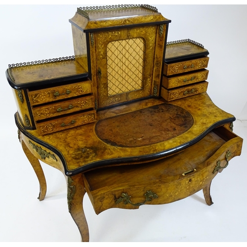 1590 - A 19thC burr walnut Bonheur du jour, with a brass gallery surmounting the two banks of three short d... 