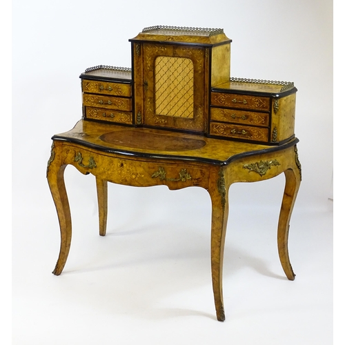 1590 - A 19thC burr walnut Bonheur du jour, with a brass gallery surmounting the two banks of three short d... 