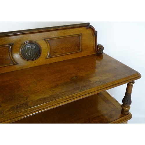 1598 - A late 19thC oak buffet, with a shaped upstand, carved edges, burr panels and carved roundel to the ... 