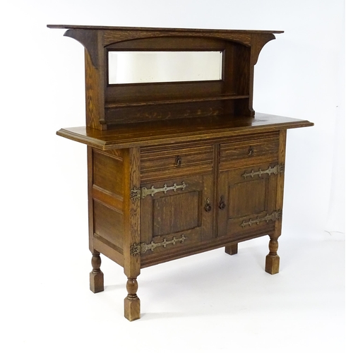 1605 - A late 19thC oak Arts and Crafts sideboard, attributed to Liberty & Co. Having a flat cornice above ... 