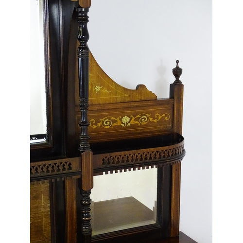 1628 - A late 19thC / early 20thC rosewood sideboard with a mirrored back, pierced galleries, turned suppor... 