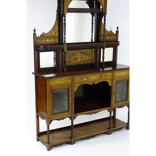 1628 - A late 19thC / early 20thC rosewood sideboard with a mirrored back, pierced galleries, turned suppor... 