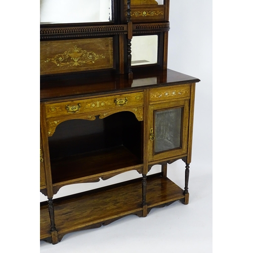 1628 - A late 19thC / early 20thC rosewood sideboard with a mirrored back, pierced galleries, turned suppor... 