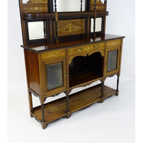 1628 - A late 19thC / early 20thC rosewood sideboard with a mirrored back, pierced galleries, turned suppor... 