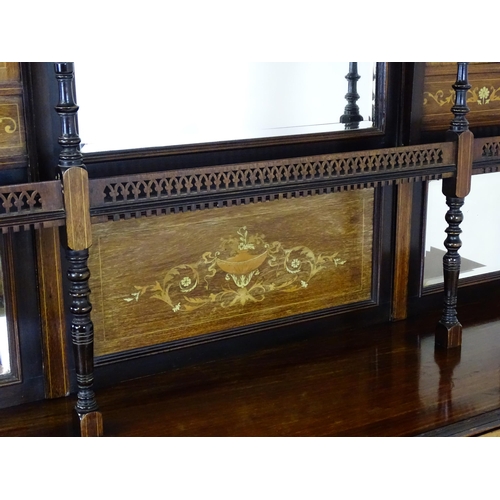 1628 - A late 19thC / early 20thC rosewood sideboard with a mirrored back, pierced galleries, turned suppor... 