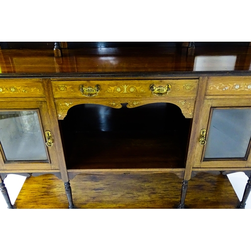 1628 - A late 19thC / early 20thC rosewood sideboard with a mirrored back, pierced galleries, turned suppor... 