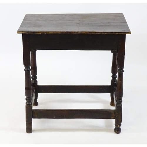 1701 - An 18thC oak side table with a later top and single short drawer above four turned legs united by a ... 