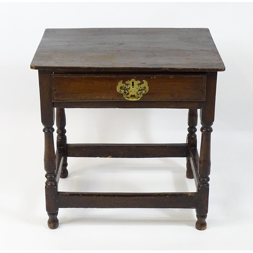 1701 - An 18thC oak side table with a later top and single short drawer above four turned legs united by a ... 