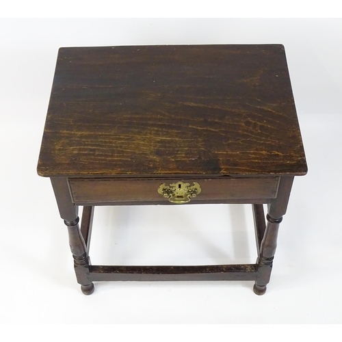 1701 - An 18thC oak side table with a later top and single short drawer above four turned legs united by a ... 