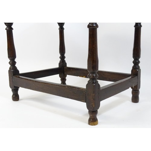 1701 - An 18thC oak side table with a later top and single short drawer above four turned legs united by a ... 