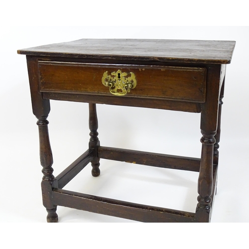 1701 - An 18thC oak side table with a later top and single short drawer above four turned legs united by a ... 