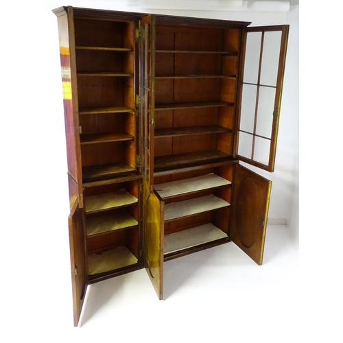 1726 - A large Georgian mahogany bookcase with a moulded cornice above three astragal glazed doors and the ... 