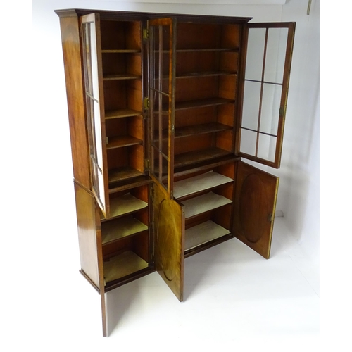 1726 - A large Georgian mahogany bookcase with a moulded cornice above three astragal glazed doors and the ... 