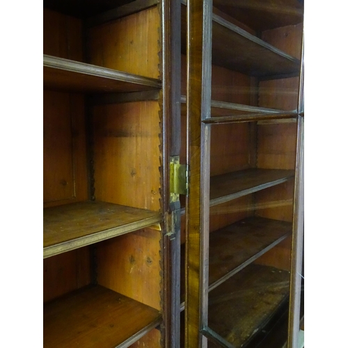 1726 - A large Georgian mahogany bookcase with a moulded cornice above three astragal glazed doors and the ... 